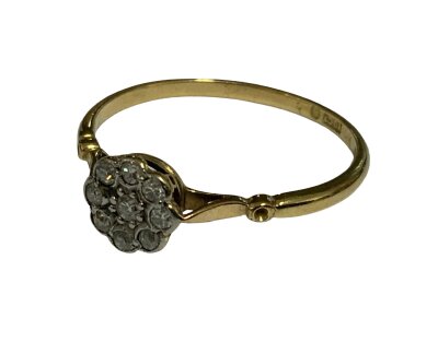 An 18ct yellow gold ring set with a pattern of diamonds. Size T.