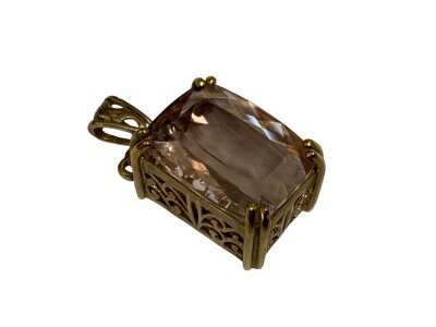 A large faceted Amethyst cushion cut stone inset in a 9ct gold pendant mount.