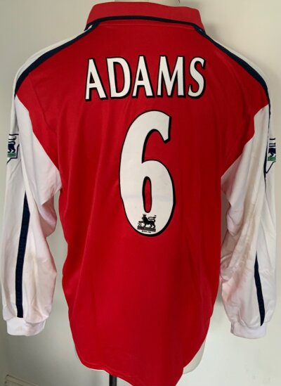 2000 - 2001 Arsenal Adams Match Worn Football Shirt + Arm Band: Long sleeve red Dreamcast shirt with Premier League badging  and number 6 Adams to rear. Worn in match v Leicester on 26 12 2000 in which he scored the 6th goal in a 6-1 win. COA signed by Adams. Whilst shirts are washed there is still mud staining to white sleeve. C/W his captains arm band that he wore that day.