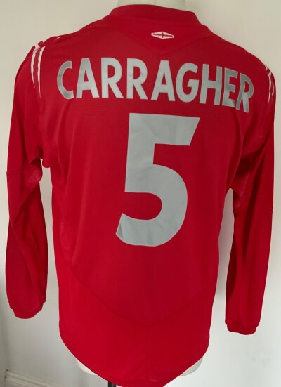 2005 England Carragher Match Prepared Football Shirt: Red long sleeve shirt with Carragher 5 to rear and to front above the words No To Racism is also a number 5. Match details to lower front state England v Holland 09 02 2005. Please note this was not worn as the finished article had a No Racism sleeve patch.