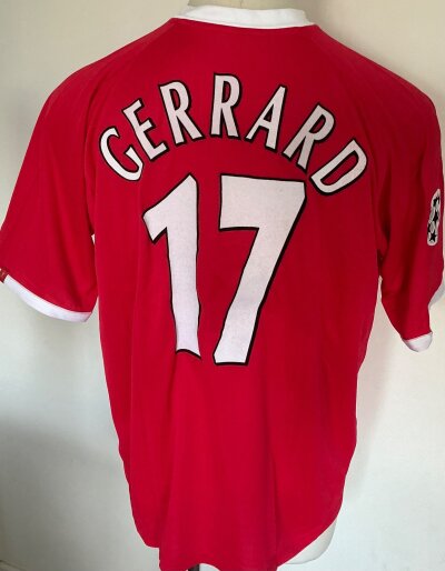 Liverpool 2001 - 2002 Gerrard Match worn Football Shirt: Red short sleeve with yellow Carlsberg sponsorship and badge. Champions League badging to arm and number 17 Gerrard to rear. Worn in match v Borussia Dortmund with two photos of him wearing shirt of which one is signed.