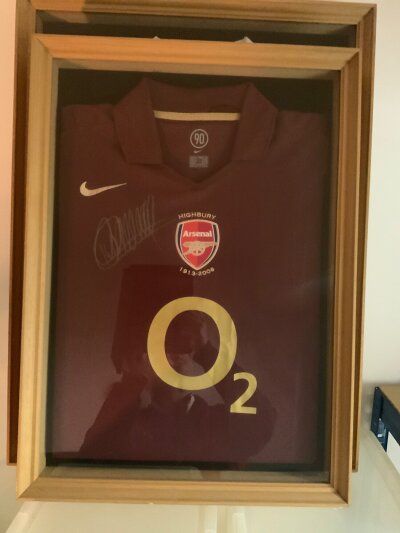 Arsenal Framed First + Last Signed Home Football Shirts: Red Current 2005 - 2006 shirt signed by Henry. In a matching but slightly bigger frame a shirt from the first season at the Emirates signed to front by 19 including Henry. Full list of autographs  online with receipt for over 300 pounds with COA for 06/07 shirt. Nicely framed. (2)