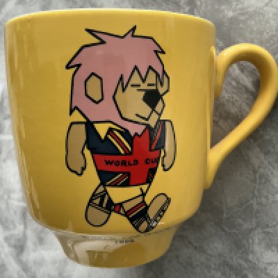 1966 World Cup Willie Yellow Football Mug: Stunning condition mug with a colourful WC Willie to one side. Football Association copyright to base. 