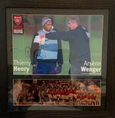 Arsenal Invincibles Signed Football Print: Signed by Wenger and Henry on a training photo. Frame also includes a team group celebration with unbeaten in 38 games wording. Frame measures 52 x 53cm.
