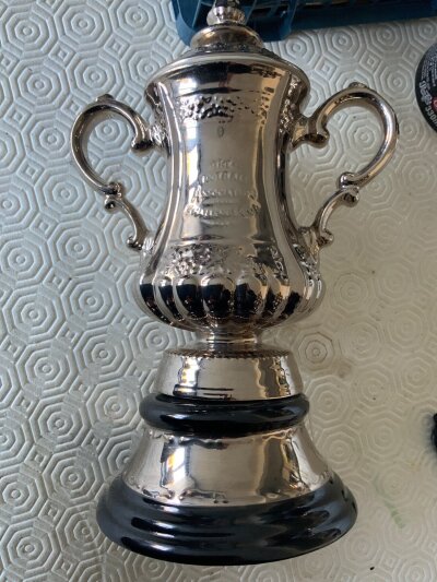 1998 Arsenal Replica Ceramic FA Cup Trophy: Stunning 3 piece lifelike FA Cup with base stating FA Cup Final 1998 and teams listed around FA logo. Nice item measuring 9 inches high.