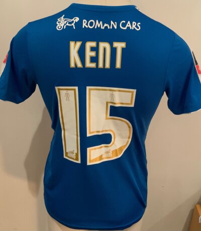Colchester 2015 - 2016 Match Worn Football Shirt: Blue and white short sleeve shirt. Number 15 Kent to rear. Match Worn v Tottenham in the FA Cup.