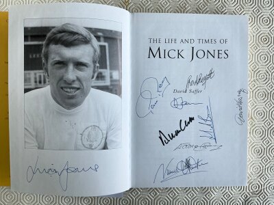 Leeds United Multi Signed Football Book: Mick Jones autobiography signed by him and team mates Reaney Hunter Belfitt Bates Harvey Gray and Clarke plus the author.