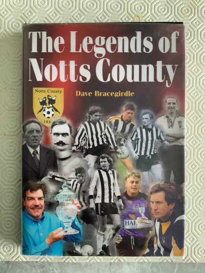 Notts County Legends Signed Football Book: 2005 Breedon Book with a picture of its greatest players and write up on opposite page. Includes Brian Bates Les Bradd Mark Draper Ian Hendon Tommy Johnson Jimmy Sirrel and Dean Yates. There are 36 signed to their picture and a further 9 at the back of the book.