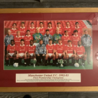 Manchester United Signed Framed 92/93 Premier League Champions Photo: Measuring 32 x 24 inches nicely framed with players identified underneath. There are 25 staff pictured including Alex Ferguson Brian Kidd Kit man and physio. Autographs are in biro so not bold but consistent with the era. Although Ferguson is faint because its blue biro on blue jacket you can see an autograph for 24 of the 25 with only Neil Webb missing. Nice item entitled First Premier Champions. 