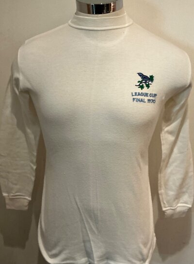 West Brom 1970 League Cup Final Match Worn Football Shirt: White excellent condition long sleeve number 10 shirt. Under Throstle on breast badge is the words League Cup Final 1970. Original Umbro neck label still attached and all in good condition. This is shirt was worn by Asa Hartford who is prepared to sign a COA for buyer.