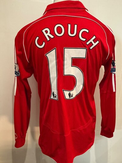 Peter Crouch Liverpool 2006 - 2008 Match Worn Football Shirt: Red long sleeve home shirt worn v Arsenal. Premier League sleeve patches to arms of which one is peeling slightly. Number 15 crouch to rear. Swapped with Kolo Toure.