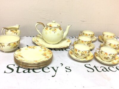 A Crown Staffordshire porcelain tea set six place setting with a yellow floral pattern no obvious damage. NO RESERVE