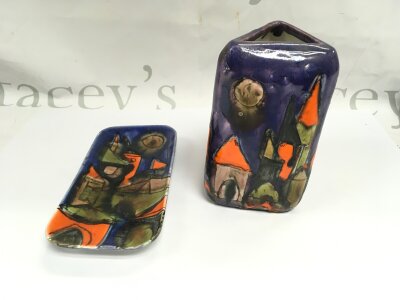 Two pieces of Eilo Schiavon ceramics featuring city motif style vibrant colours.
