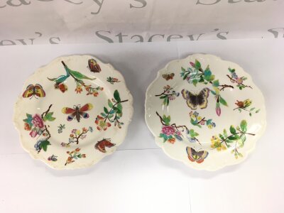 Two hand painted dishes depicting butterflies and flowers on a white ground, approx diameter 23cm.