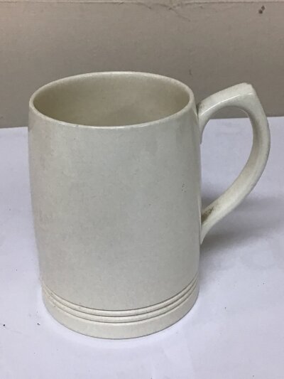 A Wedgwood mid 20th century white glazed mug designed by Keith Murray.