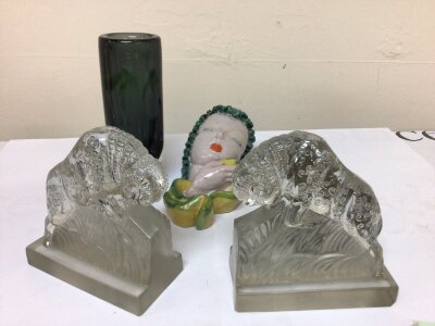 A pair of mid 20th century glass book ends in the form of stylised Rams marked on the base Tchecoslovaque  Czechoslovakia no obvious damage a mid 20th century wall mask a small Whitefriars type vase and one other wall mask (some damage)