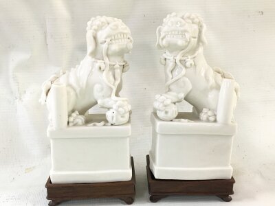 A pair of Blanc de Chine white porcelain Foo Dog incense holders, 15cm tall