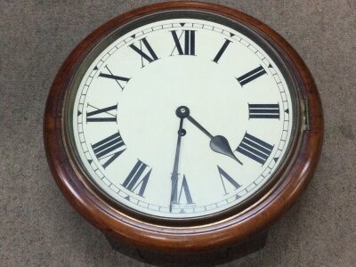 A drop dial mahogany wall clock. With key. 38cm wide