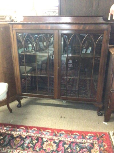 A Mahogany display cabinet with  a raised back and moulded edge above glazed doors on ball and claw feet. Width 120cm NO RESERVE