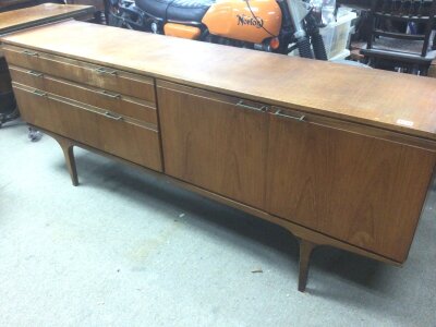 A Mid 20th century design Teak sideboard with two cupboards flanked by three graduating drawers length 199cm NO RESERVE