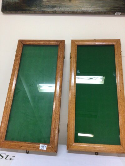 Two quality oak wall display cabinets with green baize lined. Ideal for the display of medals or objects of vertu.