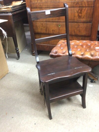 A beechwood reproduction metamorphic Library seat folding into a set of steps.