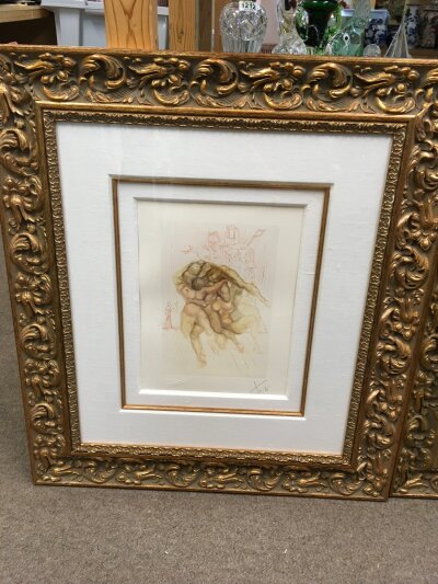 A framed and signed Salvador Dali print titled the angry ones. Frame size 62x70cm