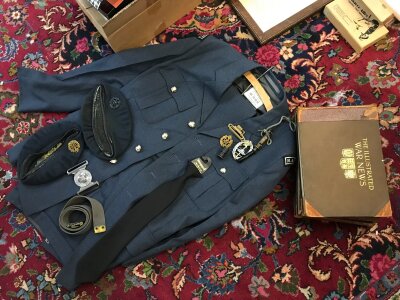 A vintage RAF uniform , hat and badges . Three volumes of the illustrated war news
