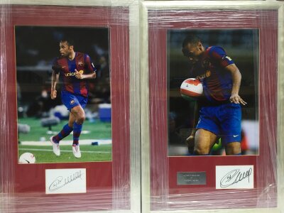 Two framed and glazed signed displays of Thierry Henry playing for Barcelona FC, approx 44cm x 66cm.
