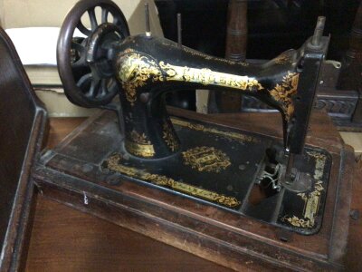 An Antique Singer Sewing machine in a dome case. NO RESERVE