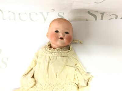A vintage AM bisque and porcelain doll.