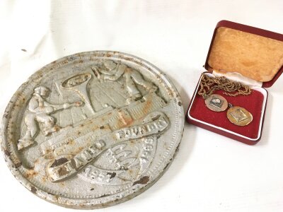A cast iron Ford plaque (19cm wide) and two silver hallmarked pendants and chain