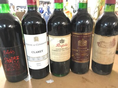 A collection of five bottle of red wine including Chateau Rolland Maillet 1983 and a 2011 House of Commons claret