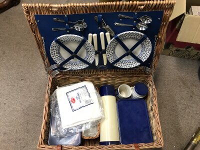 A picnic set in a wicker basket