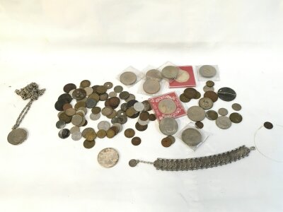 A collection of assorted coinage including a silver dollar.
