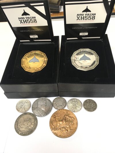 Two cased Avro Vulcan coins along with silver dollars and others.