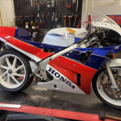 G750UYPA 1989 Honda VFR750 RC30 - One of the modern era's few immediately collectible classics, the Honda VFR750R - better known as the 'RC30' - was created for just one reason: to win the World Superbike Championship, a feat it achieved in the nascent series' first two seasons of 1988 and '89. And while American Fred Merkel was bringing Honda its first two WSB crowns, Britain's Carl Fogarty used an RC30 to win the TT F1 World Championship in 1988 and '89, and the equivalent FIM Cup in 1990. No mere short circuit scratcher, the RC30 and its derivatives proved durable enough to win a hat-full of Endurance Classics too. That this latter requirement was also part of the design brief may be determined from the fact that a quick-release front fork and single-sided swinging arm - essential for speedy wheel changes - were part of an unrivalled specification that included a twin-spar alloy beam frame, 16-valve V4 engine with gear-driven cams, close-ratio six-speed gearbox and four-pot front brake callipers. Indeed, so good was the basic RC30 that well prepared privately entered examples were often able to give the works entries a run for their money. All of which did not come cheap: at the time of its launch in 1988 an RC30 cost Â£8,499, getting on for double the cost of other super-sports 750s. Despite the passage of time and progress of motorcycle technology, the RC30 remains a match for the latest generation of sports bikes but possesses an exclusivity that none of them can approach. "No other bike from the late-Eighties is lusted after like the RC30," reckoned Bike magazine, and few would disagree. Delivered new in the UK - CHECK LOGBOOK! , this particular RC30 has been owned by the current vendor since 2017 and has recorded only CHECK BIKE. The Honda has been well stored and recently recommissioned after being off the road since 1994. Accompanying paperwork consists of V5C registration document, 2 Keys and MOT.