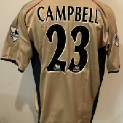 Arsenal 2001 - 2002 Gold Sega Match Worn Football Shirt: Nike iconic gold short sleeve shirt with blue collar and Sega sponsorship. Campbell 23 to rear. Worn by Sol Campbell v Southampton on 13 10 2001 with a COA signed by him.