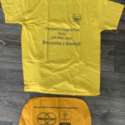 Arsenal 2006 Champions League Football Memorabilia: Removed from seat when entering the stadium and unused. Yellow XL t shirt with Arsenal badge and match details to front. C/W a seat cover with venue and date sponsored by Mastercard. (2)