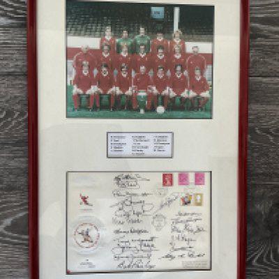 1978 Liverpool European Cup Winners Fully Signed Display: Below Liverpool team group with the European Cup is a large signed first day cover. Plaque names all the 16 that have signed. Full list is Clemence Neal Hughes Hansen Dalglish McDermott Case Fairclough Paisley Souness Callaghan Johnston Thompson Fagan and Moran. Beautifully framed in red with white boards.