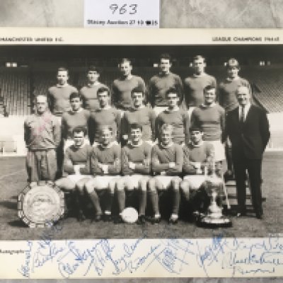 Manchester United 64/65 League Champions Signed Team Group: Large card picturing the squad with the League trophy and Charity Shield. Signed to lower border by 12 including Best Charlton Sadler Foulkes Crerand and Aston.