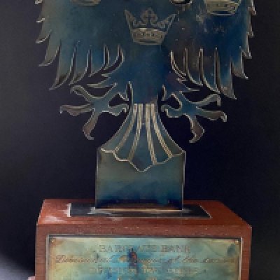 John Lyall 91/92 Ipswich Town Manager Of The Season Award: Wooden based trophy engraved to John Lyall. Photo of Lyall holding trophy when presented and another with other division winners both signed by Lyall. Ipswich tie included that he wore on the night he was presented this award.