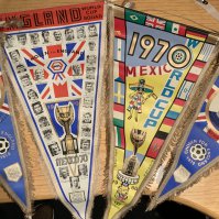 1970 England World Cup Football Pennants: 20 inch original pennants one featuring the England World Cup squad with the participating other nations flags. Two others which are 16 inches feature Hurst and Moore. 3 are made by Coffer. Excellent. (4)
