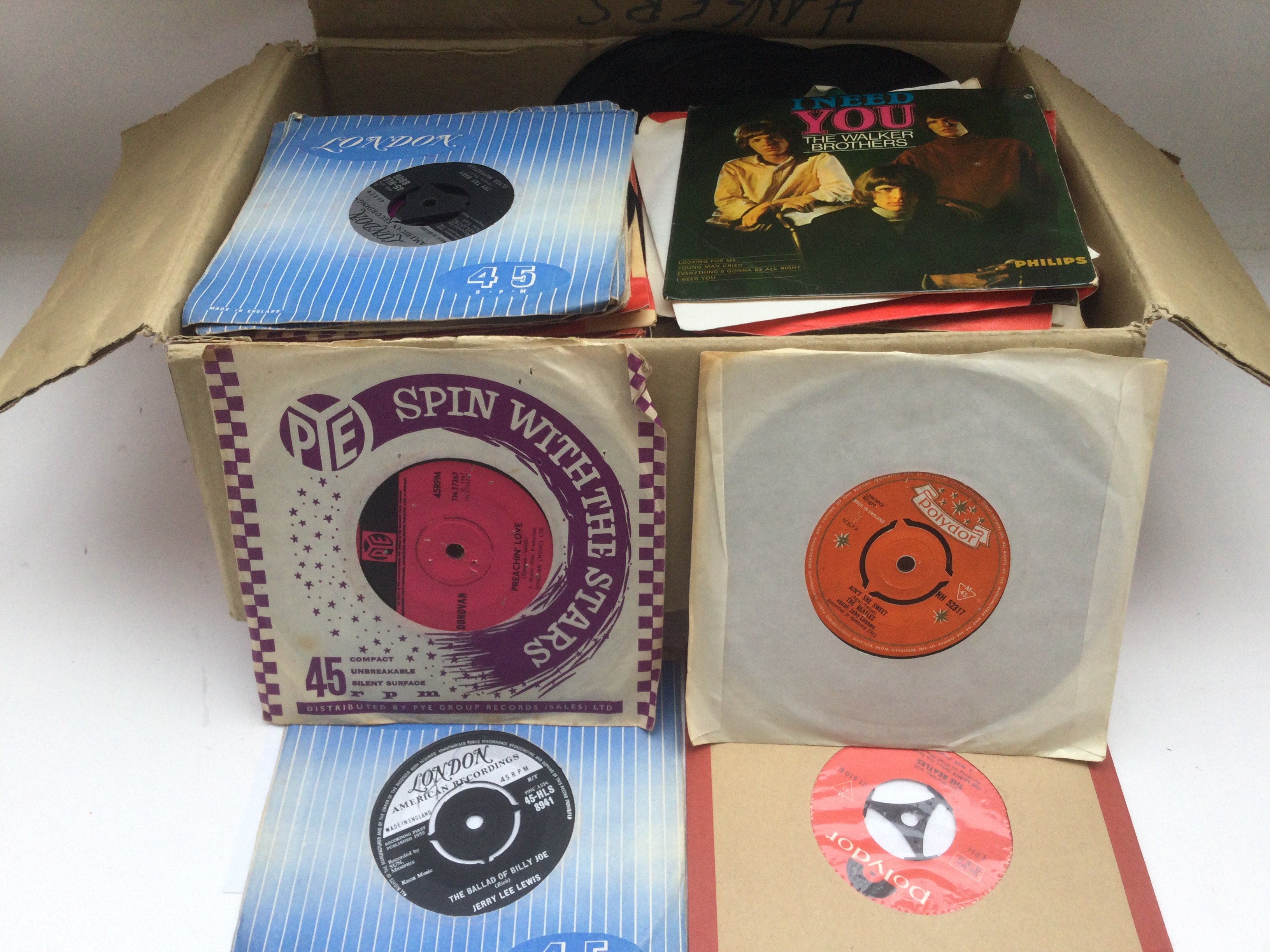 A collection of 7inch singles and EPs by various artists including a first pressing on Polydor of 'Aint She Sweet' by The Beatles.