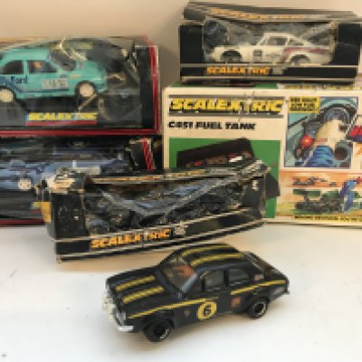 A Collection of 4 Boxed Scalextric Cars and a Fuel Tank. Boxes Are Worn.