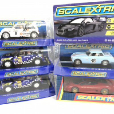 6 X Boxed Scalextric Cars. A MG Metro 6R4. 2 X Mini Countryman WRC. A Audi R8 LMS Solo Car. A MGB 1964 Searing and a Jaguar XJ220.