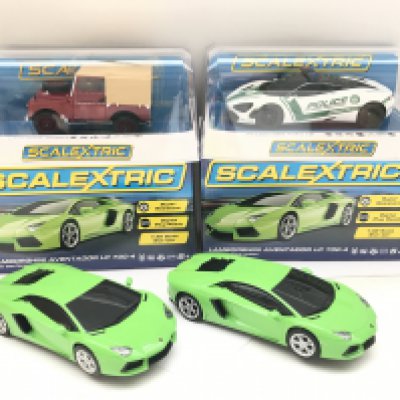 4 X Boxed Scalextric Cars. 2 X Lamborghini Adventador LP 700-4. A Land Rober Series 1 and a McLaren 720s Police Car.