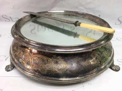 A silver plated cake stand and knife.