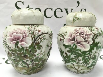 Japanese Meiji period high-relief porcelain celadon glaze ginger jars with intricate, hand-painted floral details in green and pale pink enamels. Stamped Siegfried And Brandenstein San Francisco on cover. 18cm tall