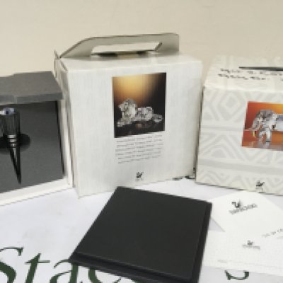 A boxed Swarovski 1995 Annual Edition Lion in a fitted box an elephant and a boxed glass bottle stopper (3) NO RESERVE